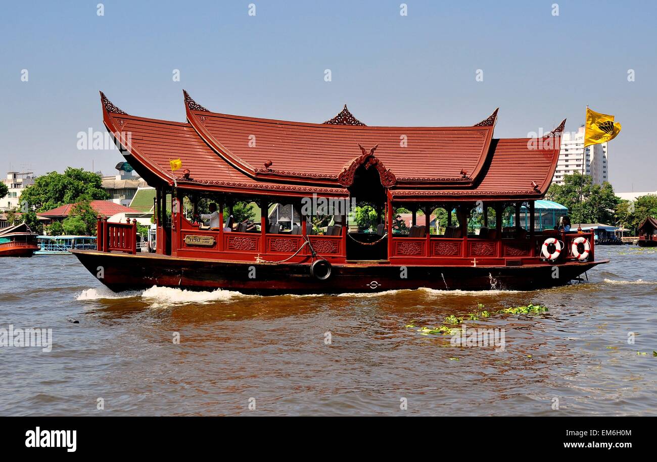Bangkok, Thailand  The Mandarin Oriental Hotel's wooden ferry transfer boat with Thai-style roofs and ornate wooden panels Stock Photo