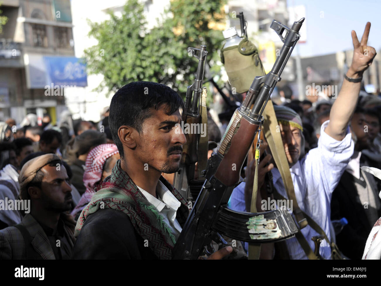 (150416) -- SANAA, April 16, 2015 (Xinhua) -- Memebrs of the Houthi group holding guns shout slogans at a rally in Sanaa, Yemen, on April 16, 2015. Thousands of Houthi members staged a demonstration on Thursday in Sanaa to protest against Saudi-led airstrikes and arms embago on the Houthi group. (Xinhua/Hani Ali) Stock Photo