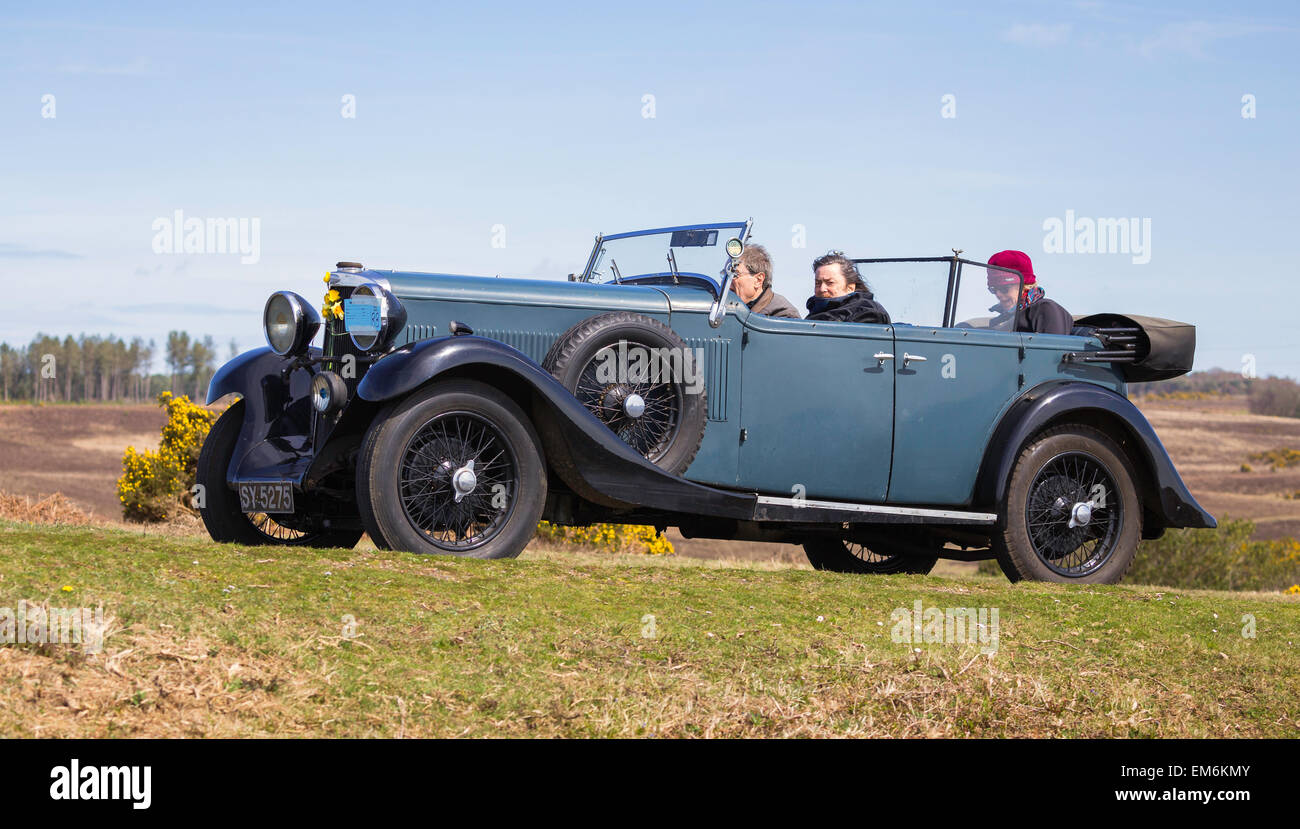 A vintage car competing in the Daffodil Run in the New Forest on a sunny day. Stock Photo