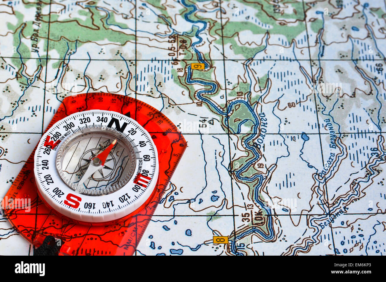 Map and compass. Photo magnetic compass located on a topographic map ...