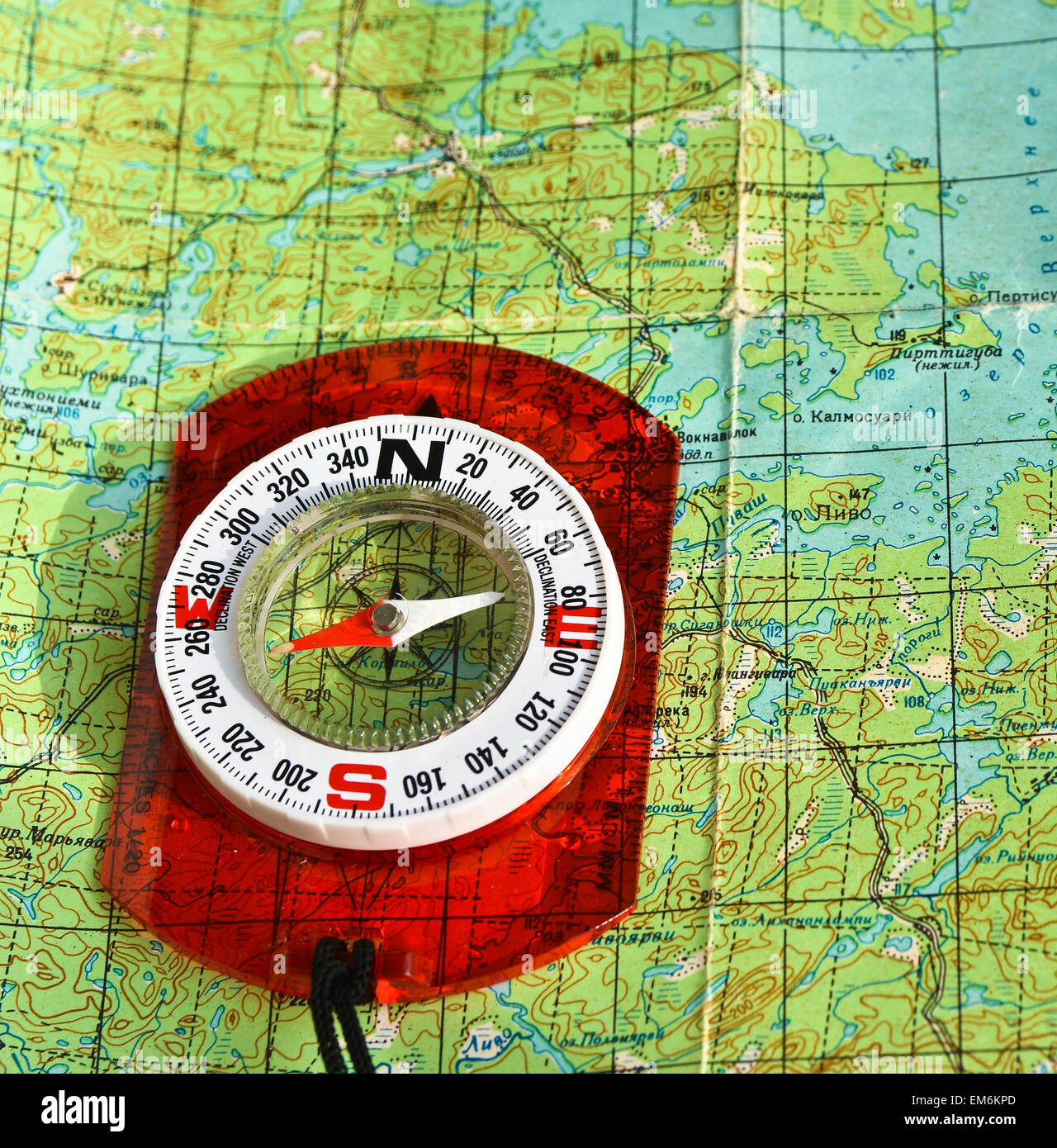 The compass on the map. Photo magnetic compass located on a topographic ...