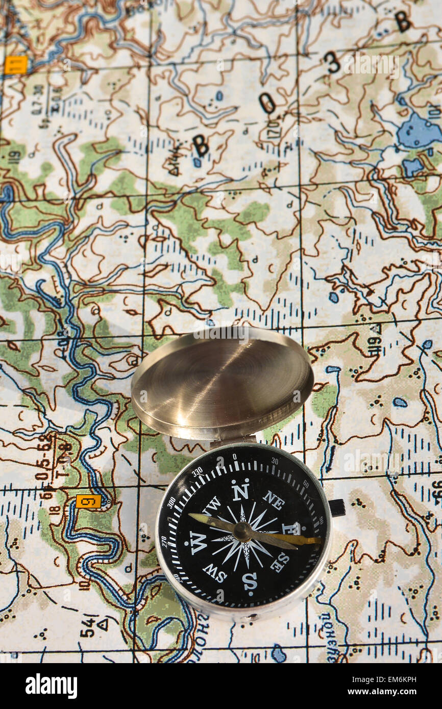 Map and compass. Photo magnetic compass located on a topographic map. Stock Photo