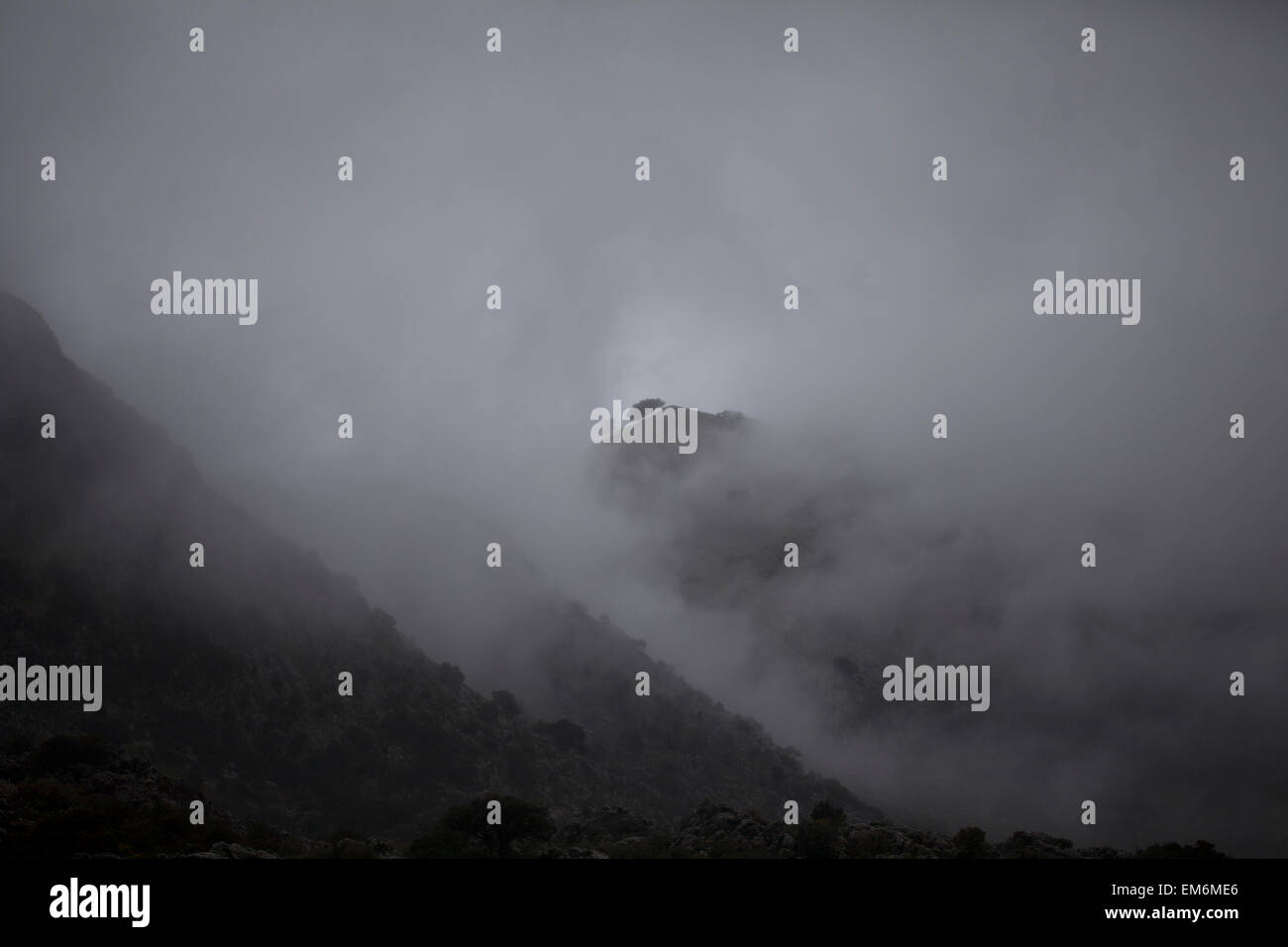 Fog covers the mountains in Villaluenga del Rosario, Sierra de Grazalema Natural Park, Cadiz province, Andalusia, Spain Stock Photo