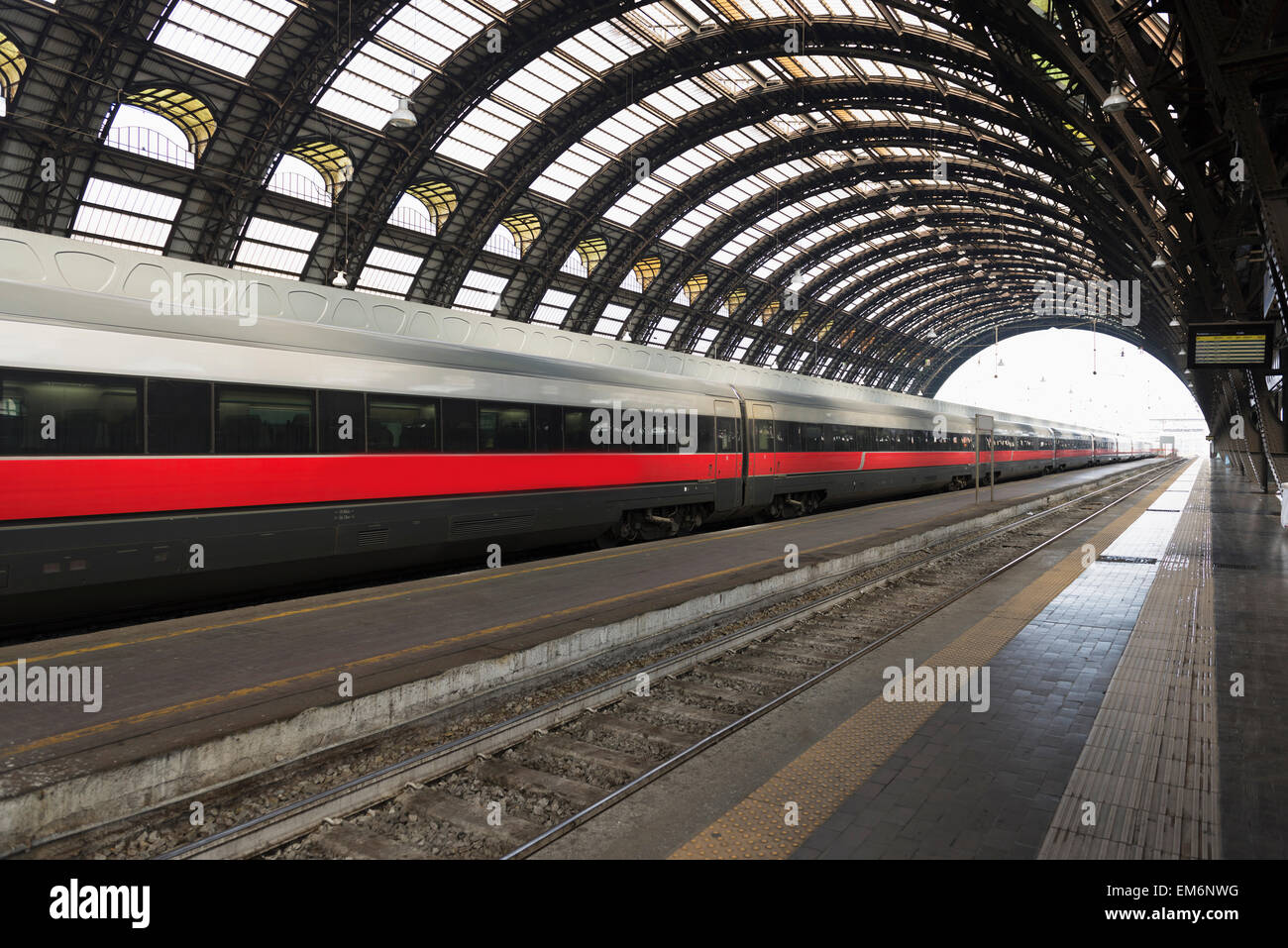 A Train On The Tracks In A Train Station With Domed Ceiling Milan