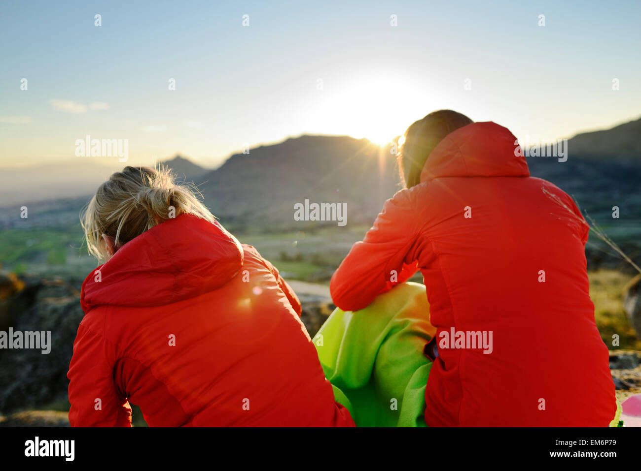 Two young women looking at sunset in Macedonia. Stock Photo