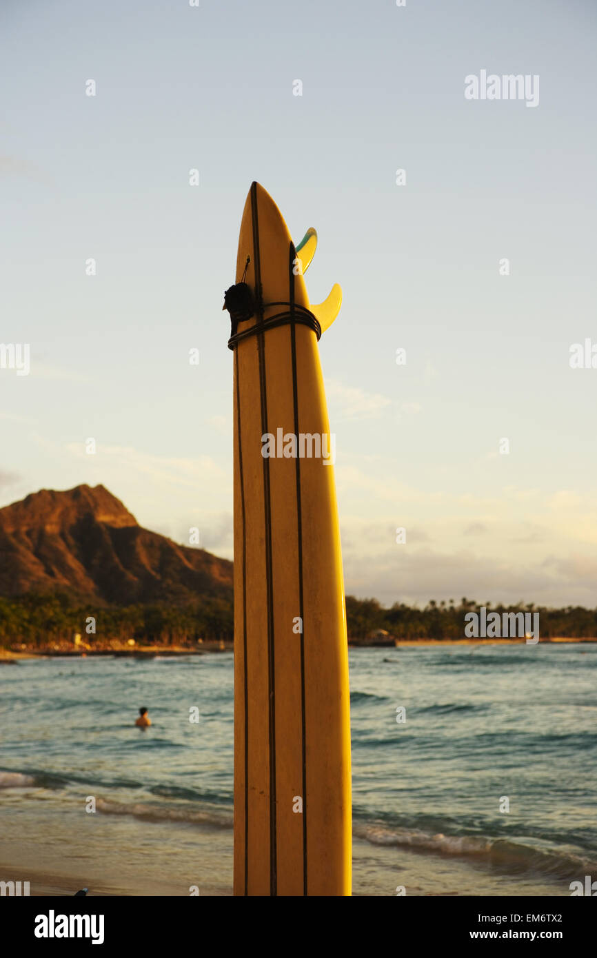 Hawaii, Oahu, Waikiki, Surfboard Stuck Into The Sand At The Waters Edge