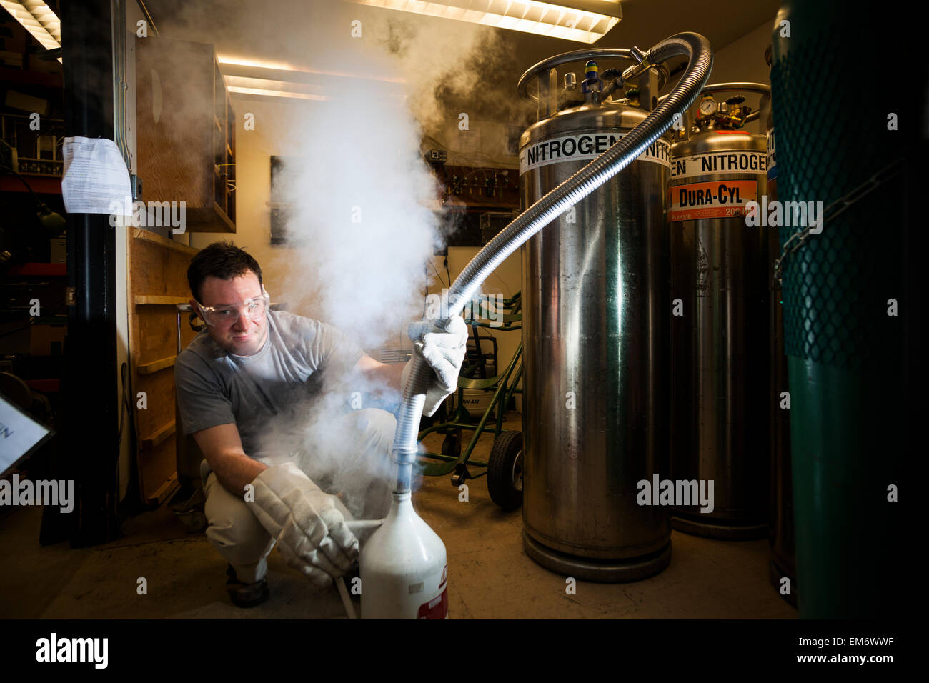 A man fills up on liquid nitrogen in a stable isotope laboratory in Boulder, Colorado. Stock Photo