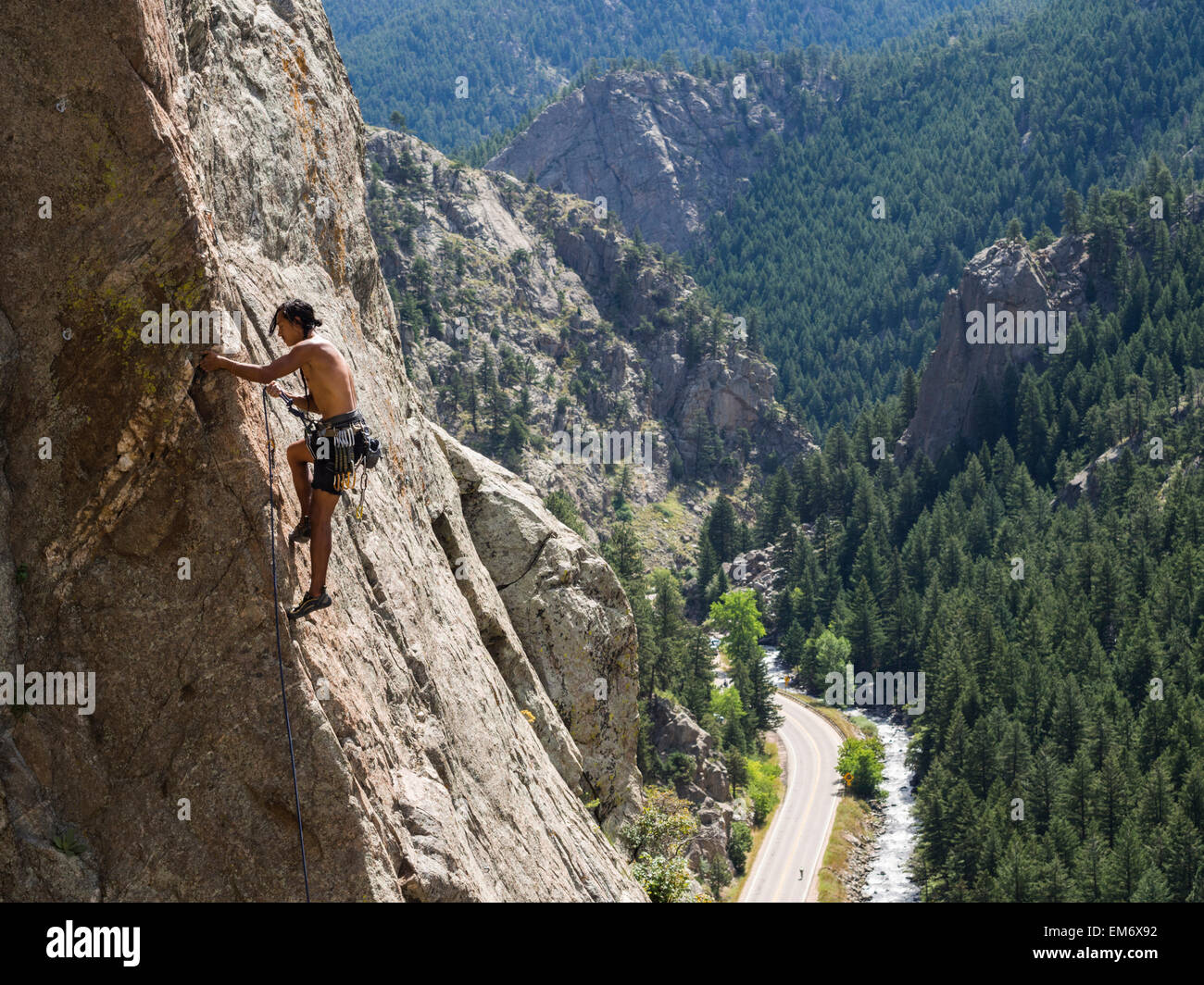 A man climbs a rock route at Sports Park in Boulder Canyon, Colorado. Stock Photo