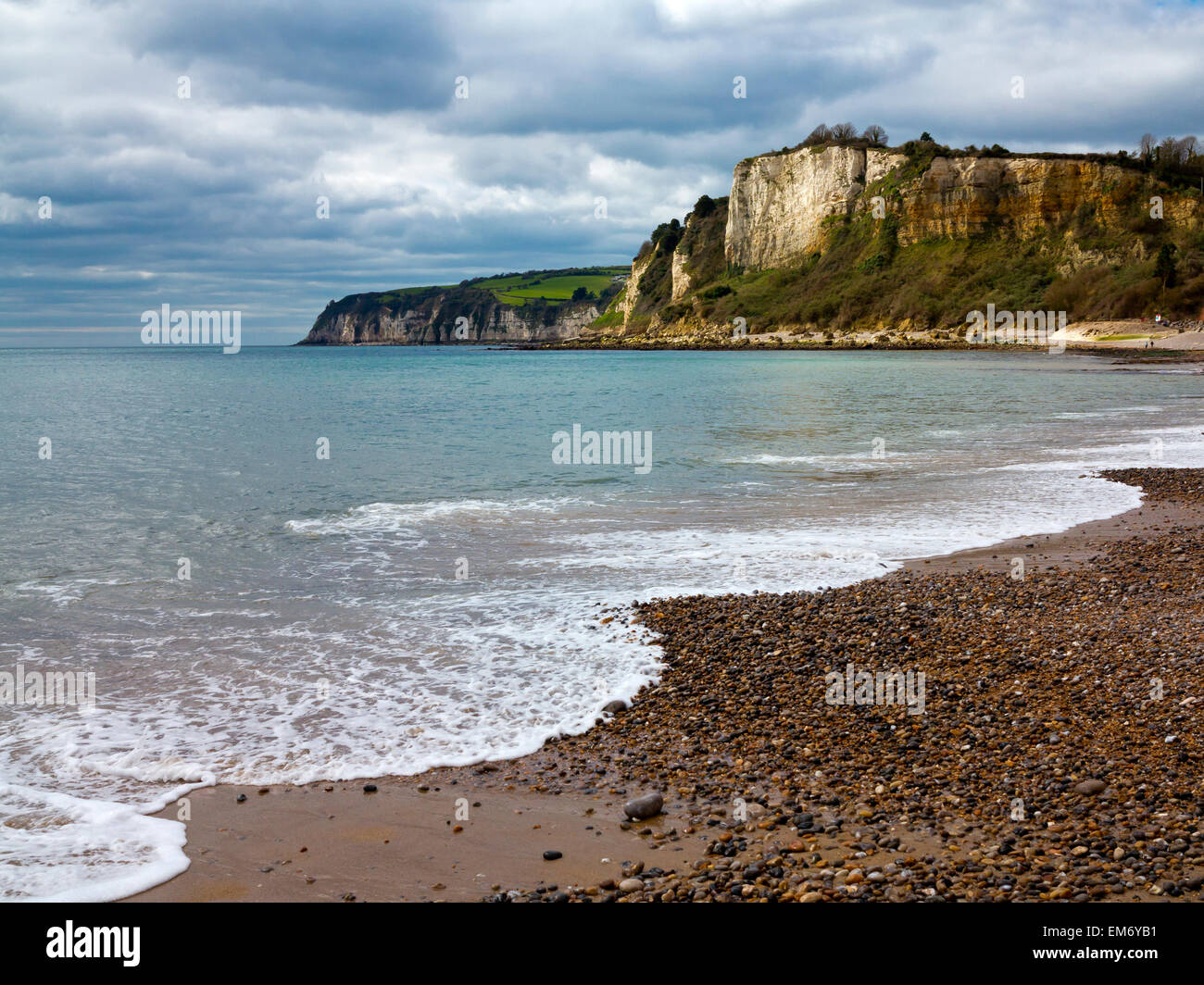 Waves breaking on to the shingle beach at Seaton looking west toward Beer cove in Devon England UK Stock Photo