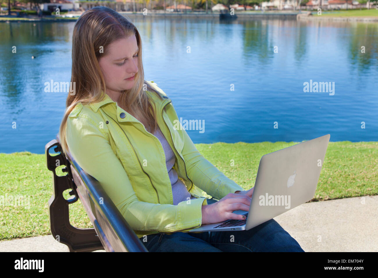 Teenage girl using mobile device outdoors lake  MR  © Myrleen Pearson Stock Photo
