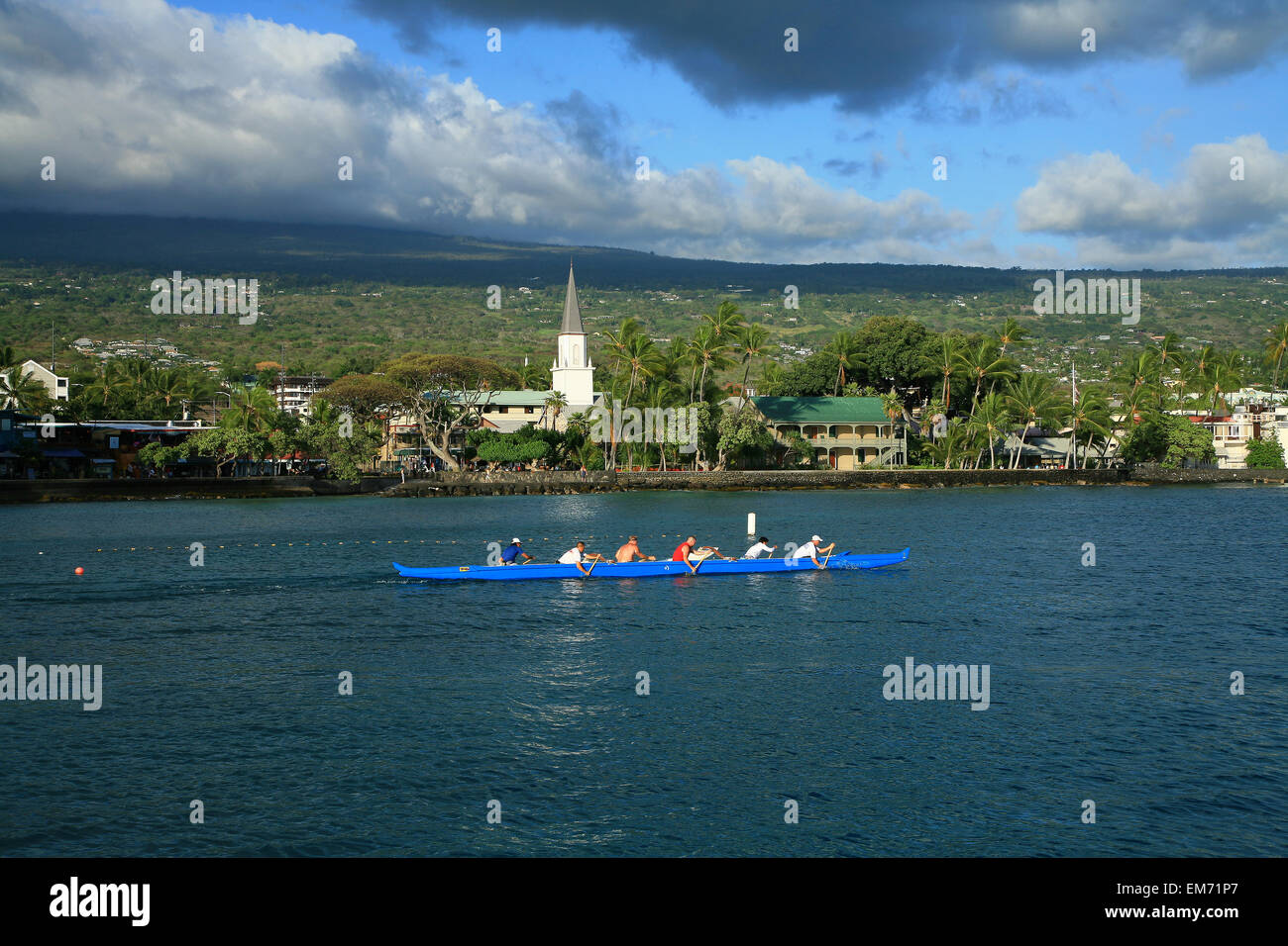Hawaii, Big Island, Kailua-Kona Town, Six Man Canoe Paddling Along Coastline Near Ali'i Drive. Stock Photo