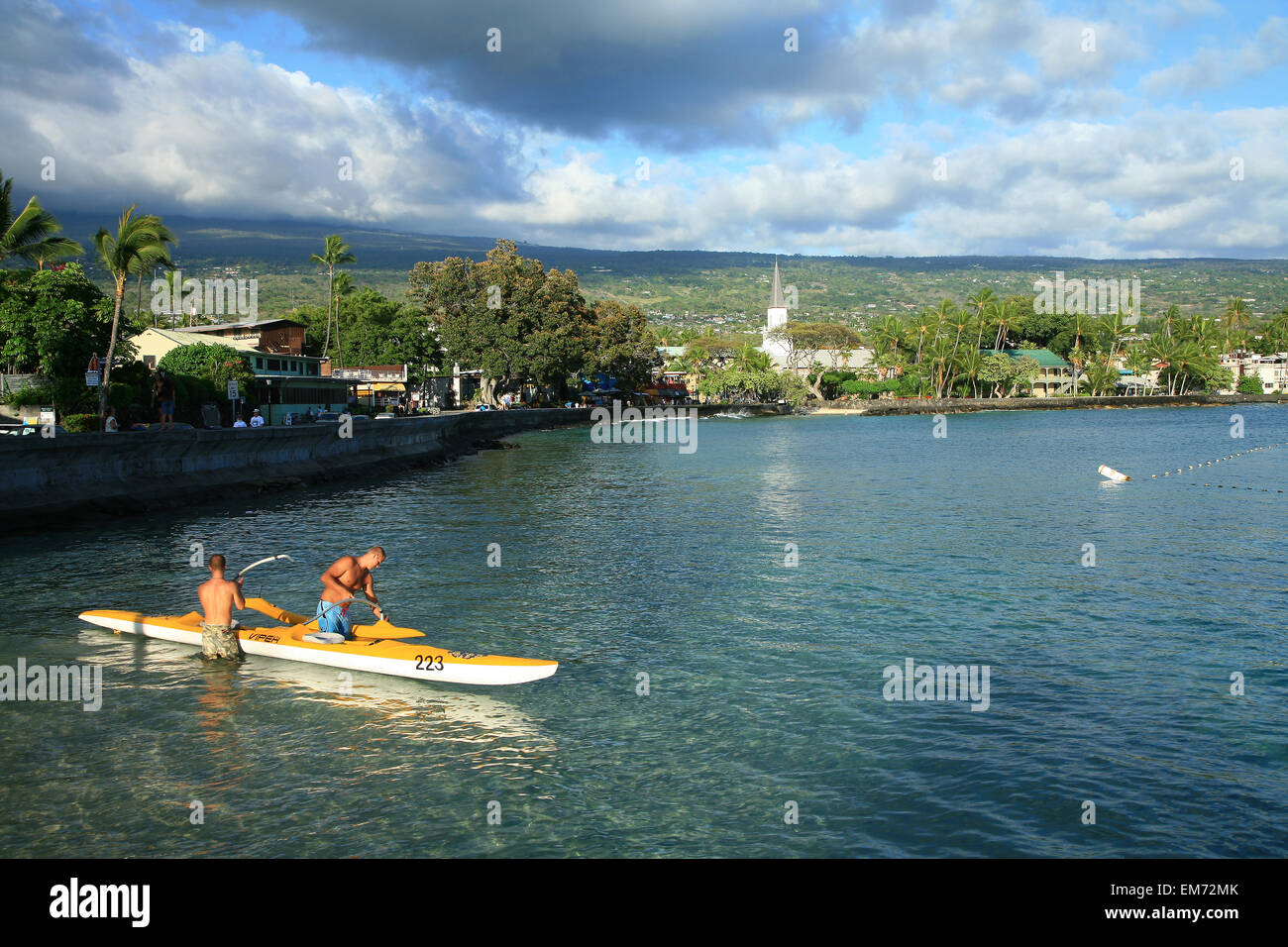 Hawaii, Big Island, Kailua-Kona Town, Men Assembling A Two Man Canoe In The Water Along Ali'i Drive. Stock Photo
