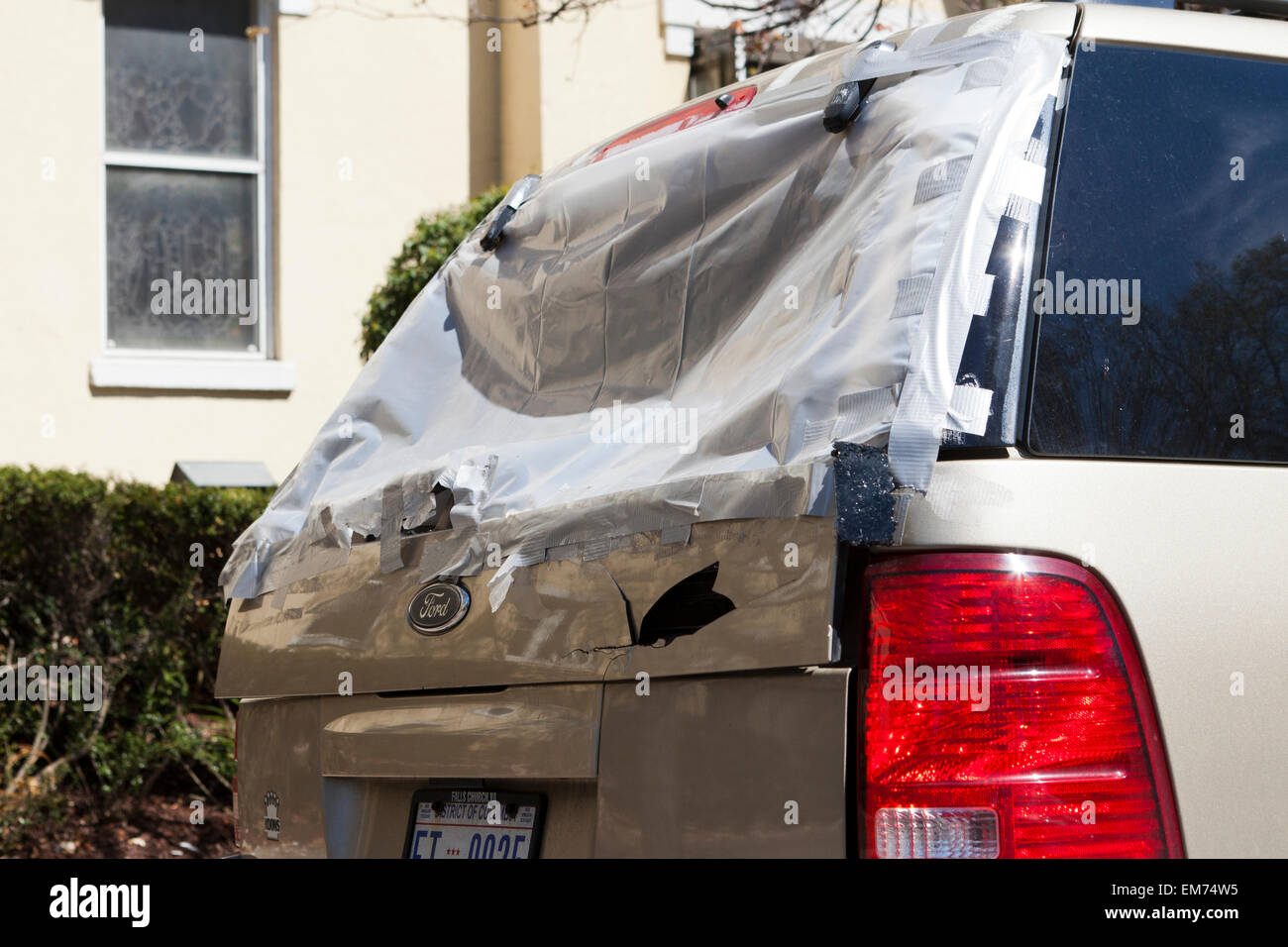 Jerry-rigged repair of broken rear windshield of SUV - USA Stock Photo