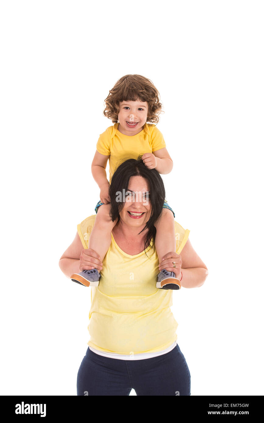 Happy mother carrying toddler boy on her shoulder and having fun