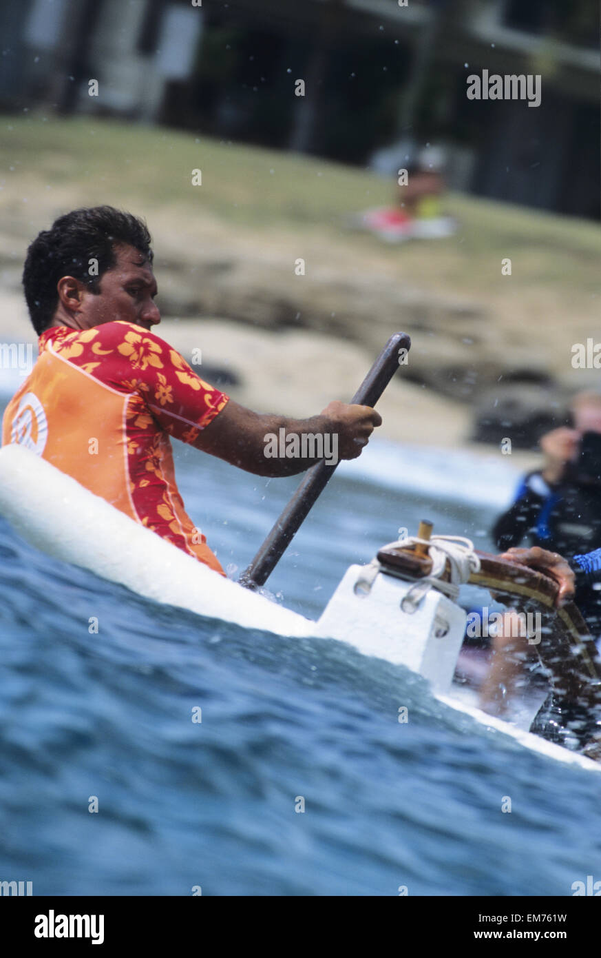 Hawaii, Oahu, Makaha, CloseUp Of Man Steering Canoe While Surfing Wave