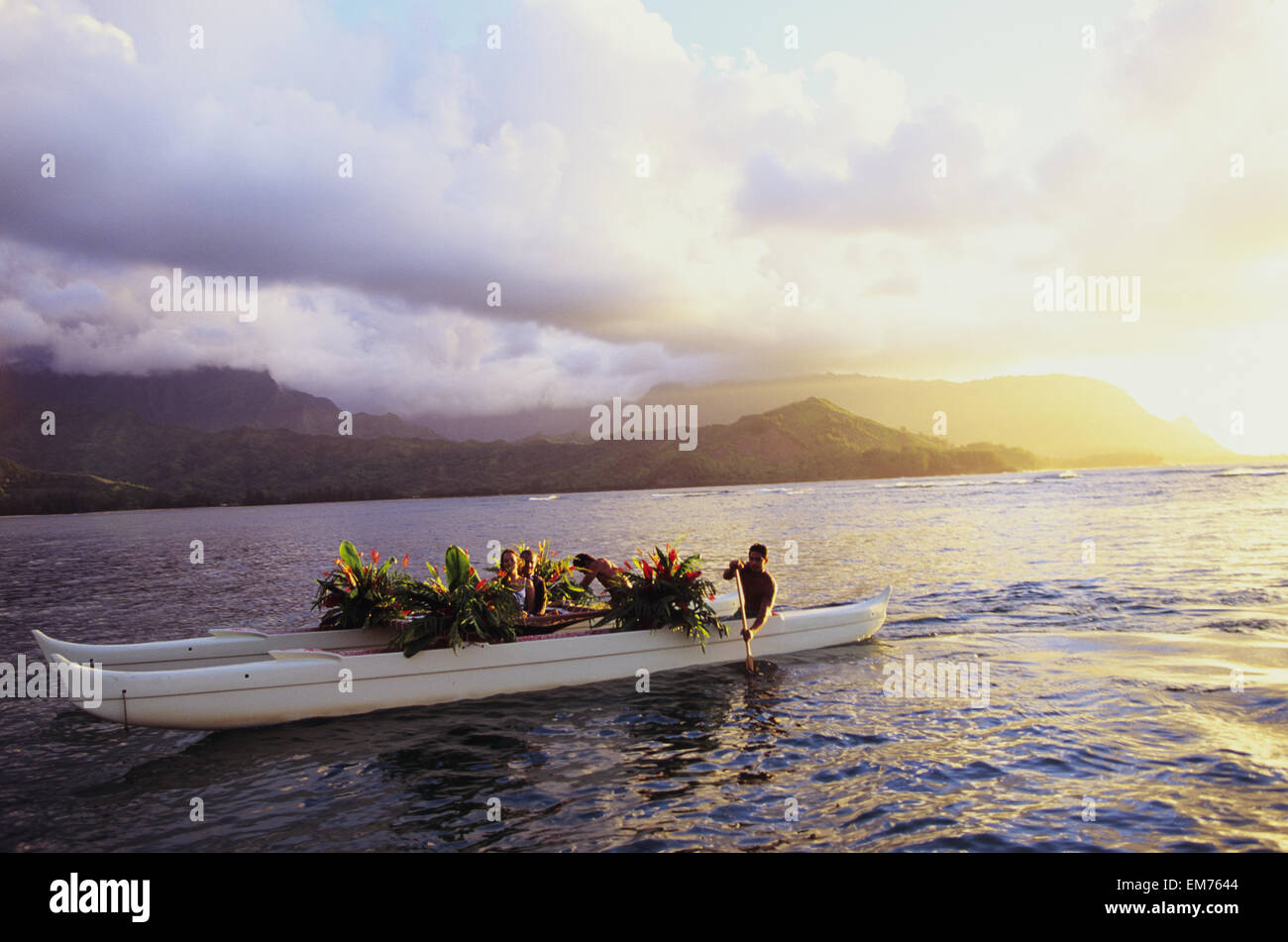 USA, Hawaii, Kauai, Couple riding in traditional double hull wedding canoe; Hanalei Bay Stock Photo