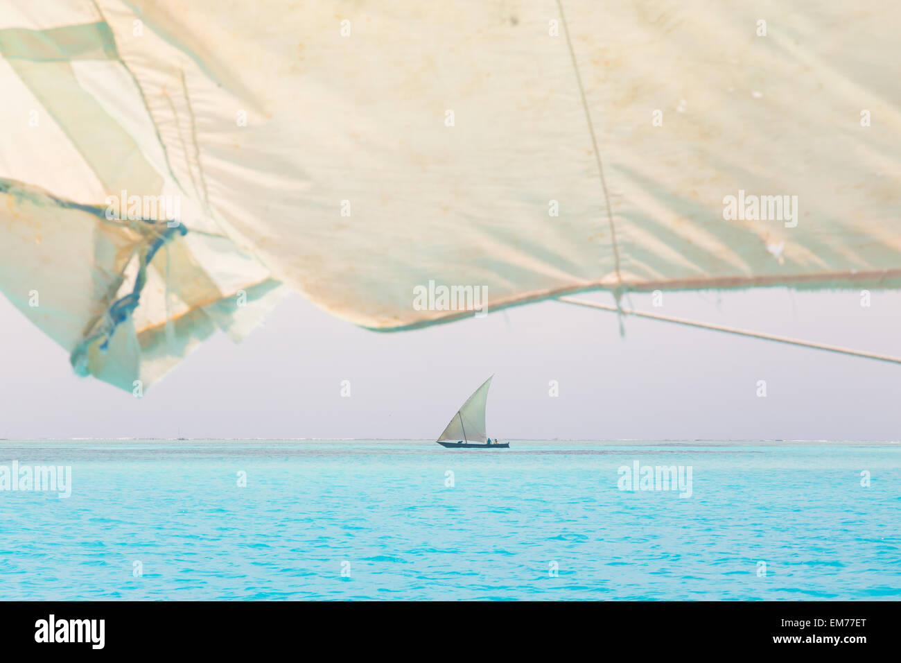 Traditional wooden sailboat sailing on horizon. Stock Photo