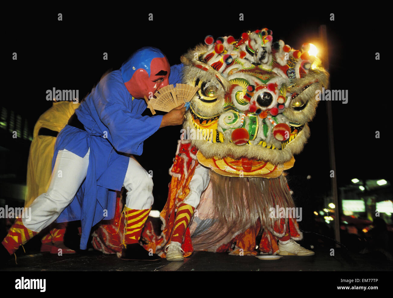 Hong Kong, Chinese New Year, Lion Dance At Night, Man In Costume Whispers In Dragons Ear No Model Release Stock Photo