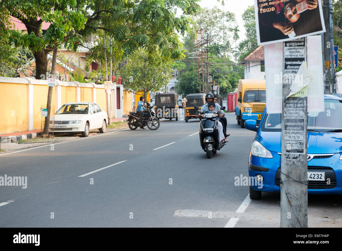 A young family riding a motorcyle in Fort Kochi, Kerala India Stock Photo