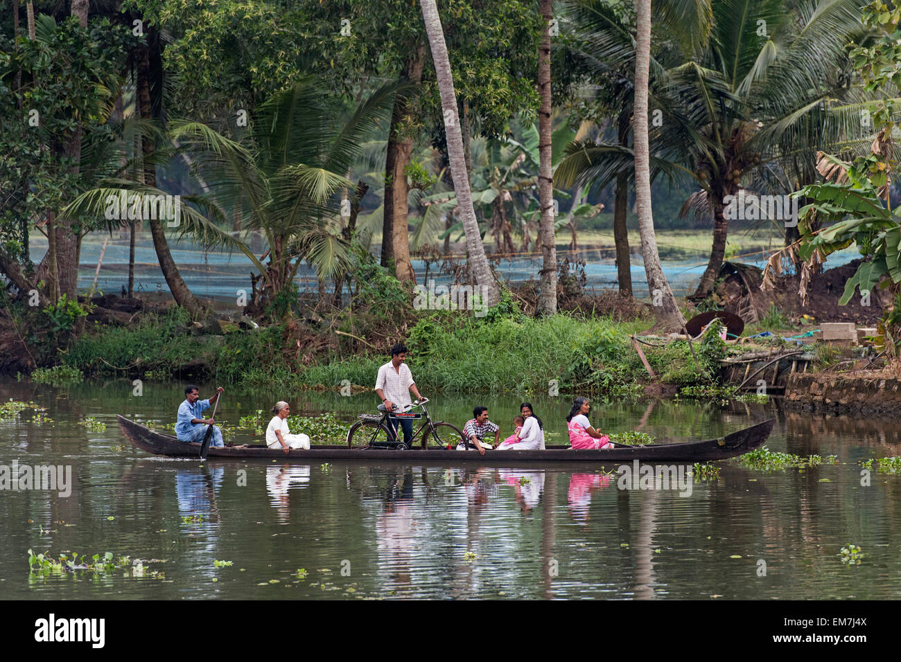 Passengers in a small boat, Backwaters canal system in Alappuzha, Kerala, India Stock Photo