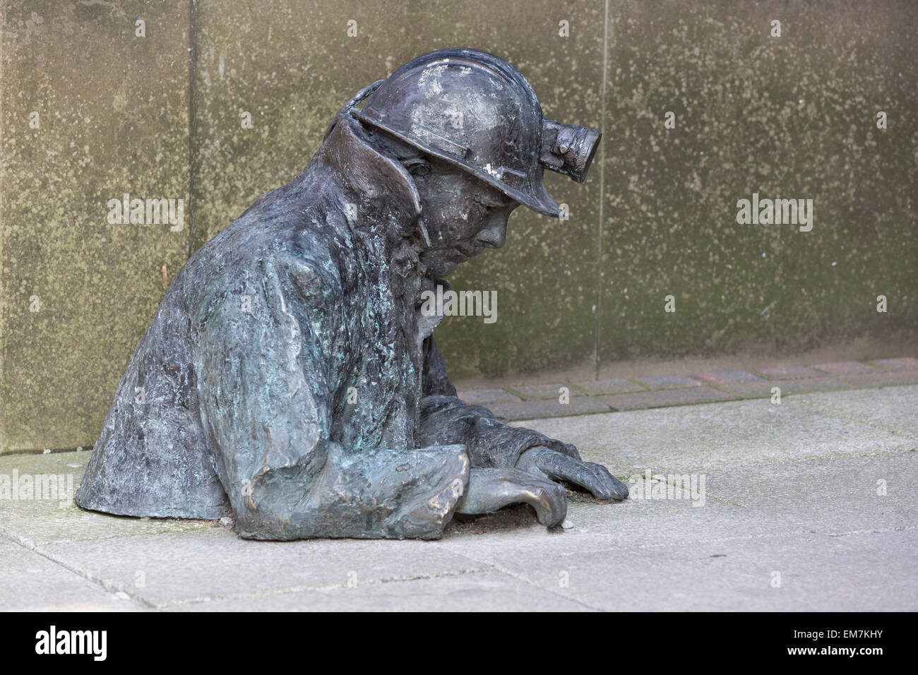Bronze street sculpture of a miner emerging from the ground, Ashton-under-Lyne, Lancashire Stock Photo
