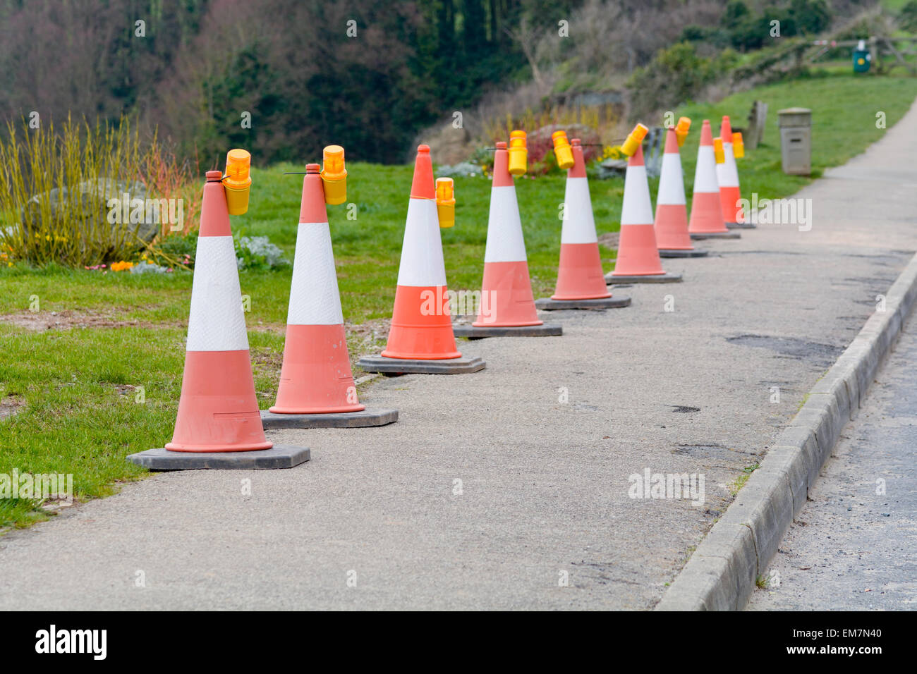 Row of traffic bollards with warning lights on the pavement Stock Photo