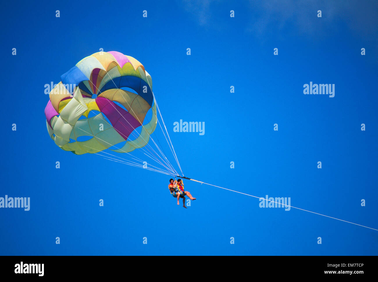 Guam, Cocos Island Resort, Couple In Blue Skies, Parasailing Stock