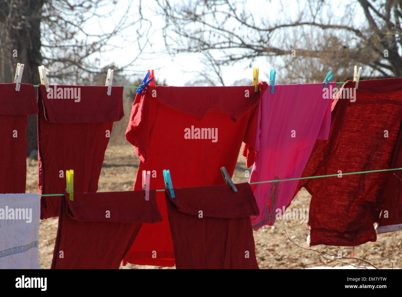 Red laundry drying in the wind. Stock Photo