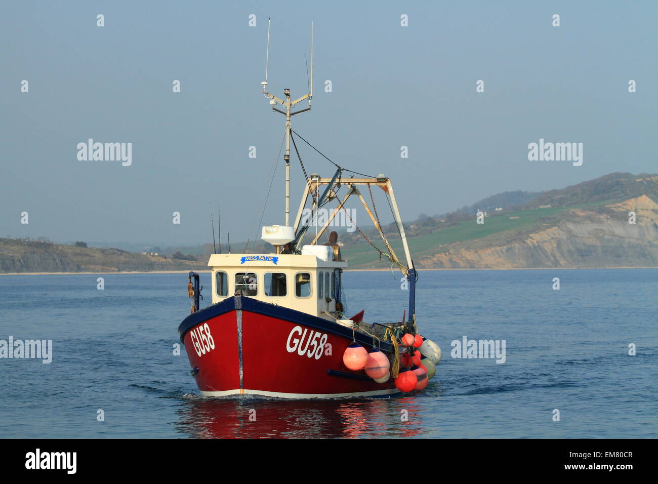 Fishing boat returning to Lyme Regis harbour, Dorset, England, UK Stock ...