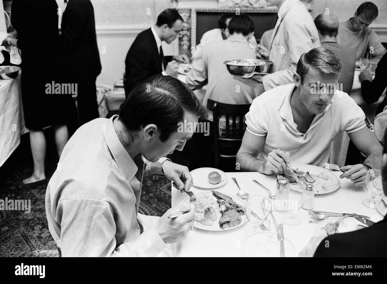 Members of the England football team Jimmy Greaves (left) and Roger Hunt eating their breakfast at the team hotel in Hendon during the 1966 World Cup tournament. 10th July 1966. Stock Photo