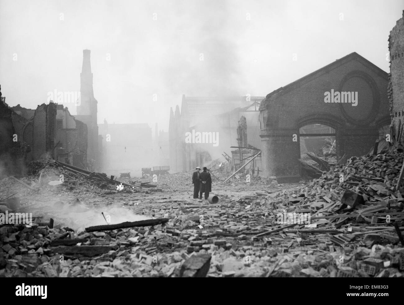 Bomb damage at Liverpool. Two people survey the damage caused by an air raid during World War Two. Circa 1940. Stock Photo