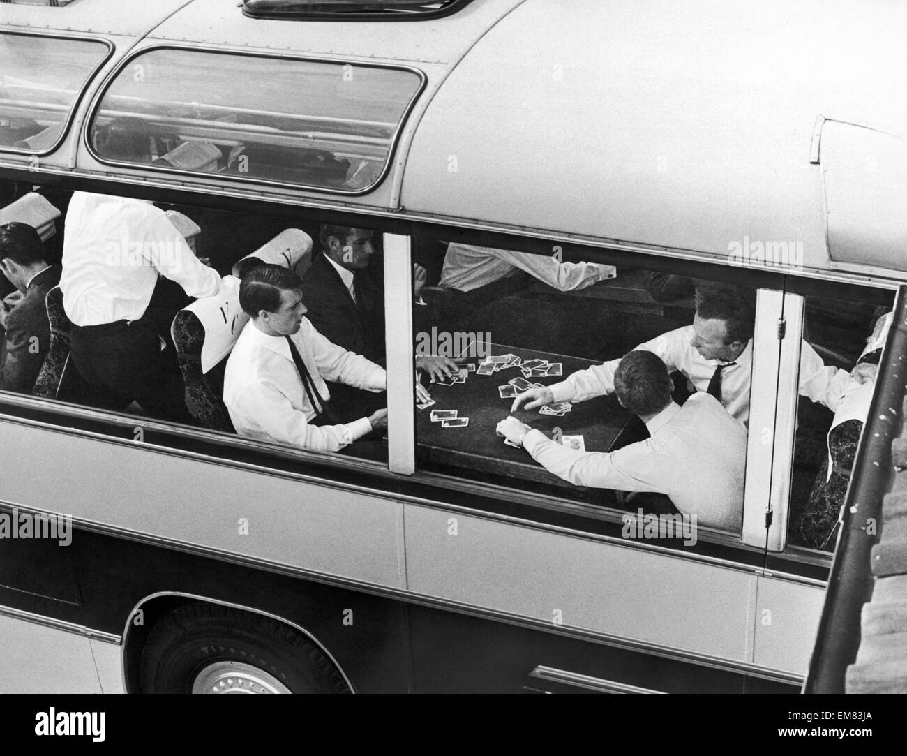 England footballers Roger Hunt, Geoff Hurst, Nobby Stiles and Alan Ball playing cards for money on the team coach during the World Cup tournament. 21st July 1966. Stock Photo