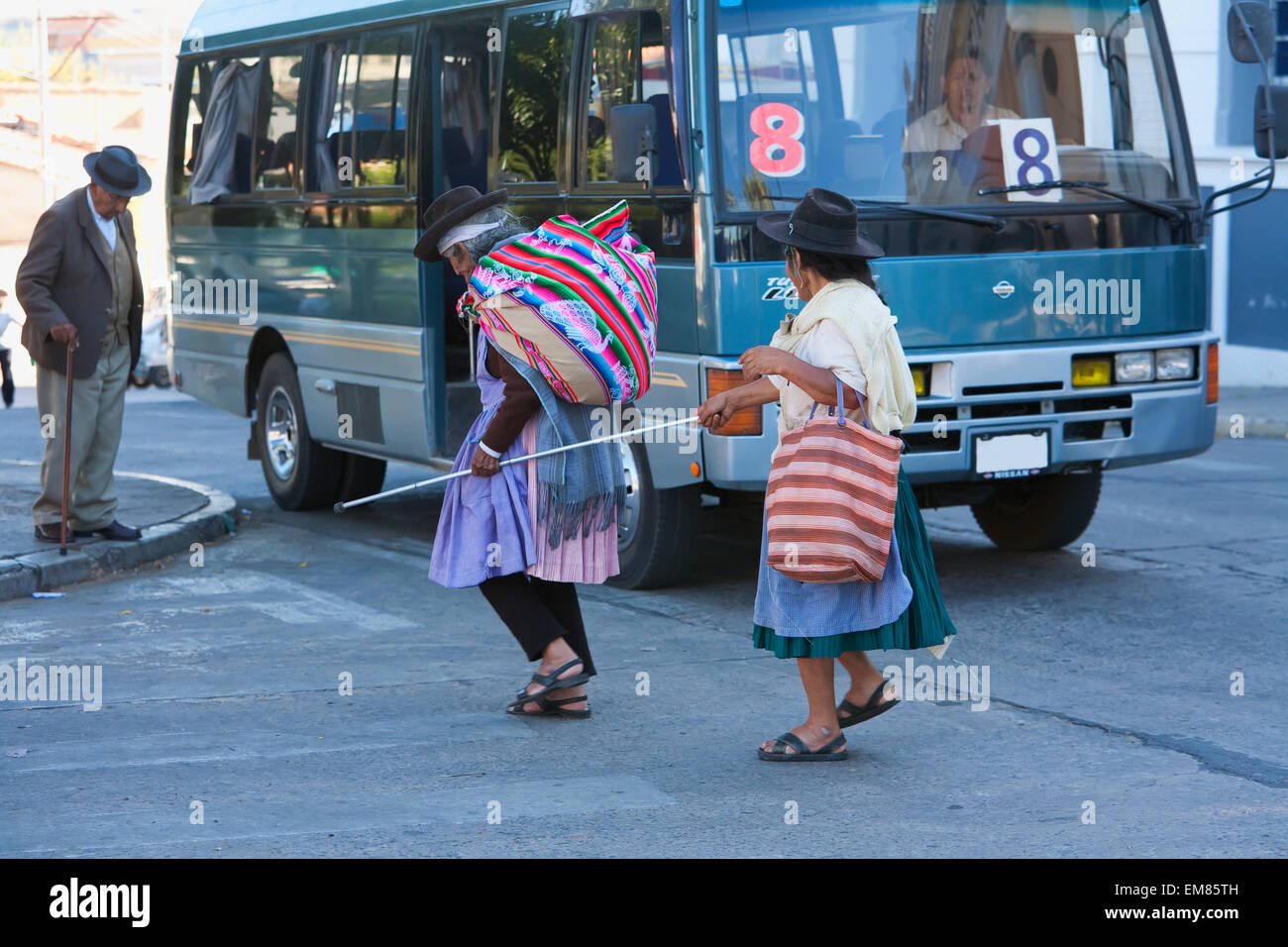 Aymara Woman Helping A Blind Woman To Cross The Street, Cementerio General, Sucre, Chuquisaca Department, Bolivia Stock Photo