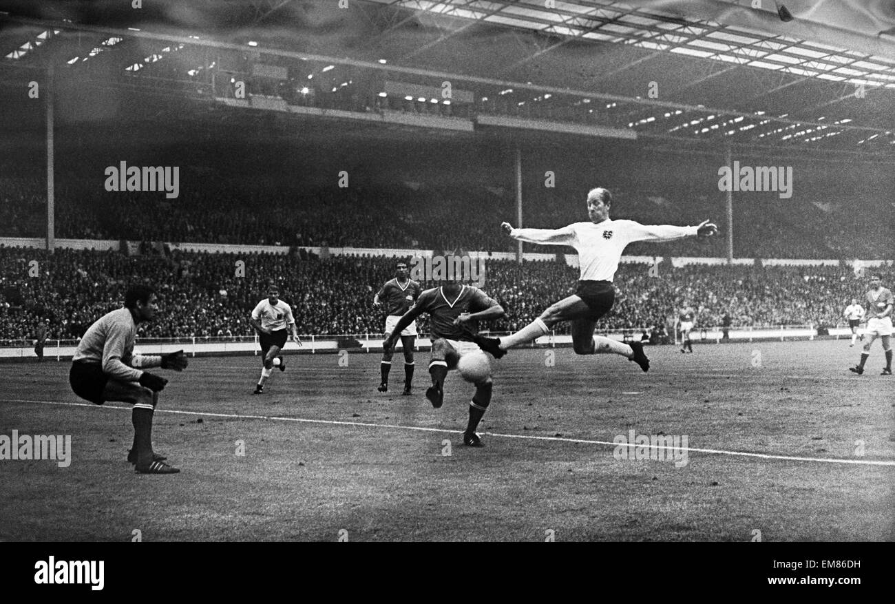 1966 World Cup Group One match at Wembley Stadium. England 2 v France 0. England's Bobby Charlton on fine form against the French defence as he leaps up to get a shot in at goal. 20th July 1966. Stock Photo