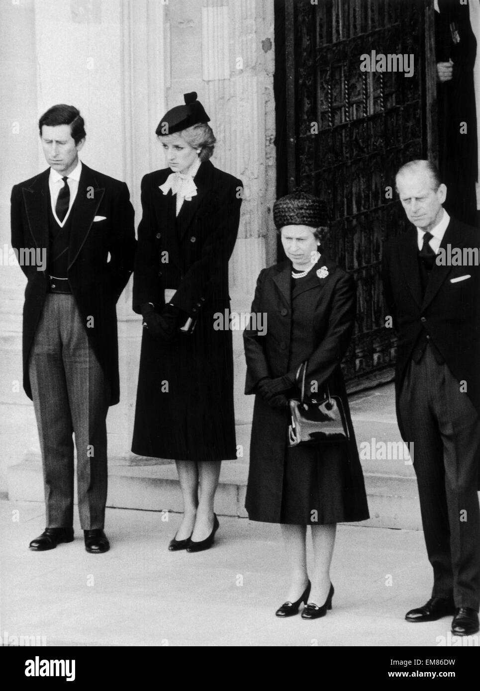 The Queen seen here with the Duke of Edinburgh and the Prince and Princess of Wales on the steps of St Georges Chapel Windsor Castle for the funeral of the Duchess of Windsor. 30th April 1986 Stock Photo