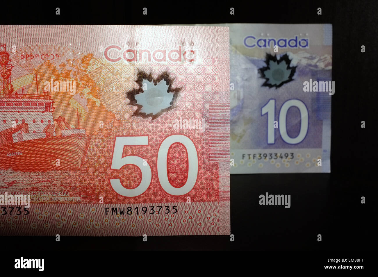 Canadian $20 notes photographed against a black background. Stock Photo