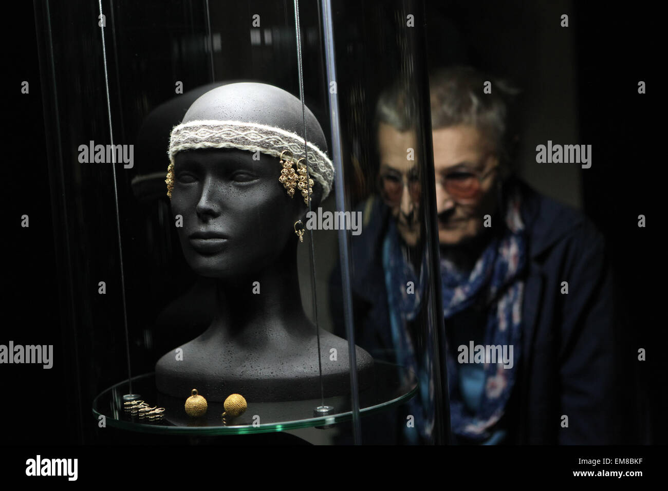 Prague, Czech Republic. 16th April 2015. A visitor examines Great Moravian golden jewellery during a press preview to the exhibition 'Great Moravia and the Beginnings of Christianity' in Prague, Czech Republic. The exhibition presenting medieval treasures and original artefacts of the first Slavic state runs in Prague Castle till June 28, 2015. Stock Photo