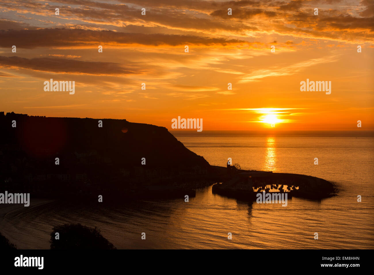 UK, England, Yorkshire, Scarborough, early morning, sun rising over harbour at dawn Stock Photo