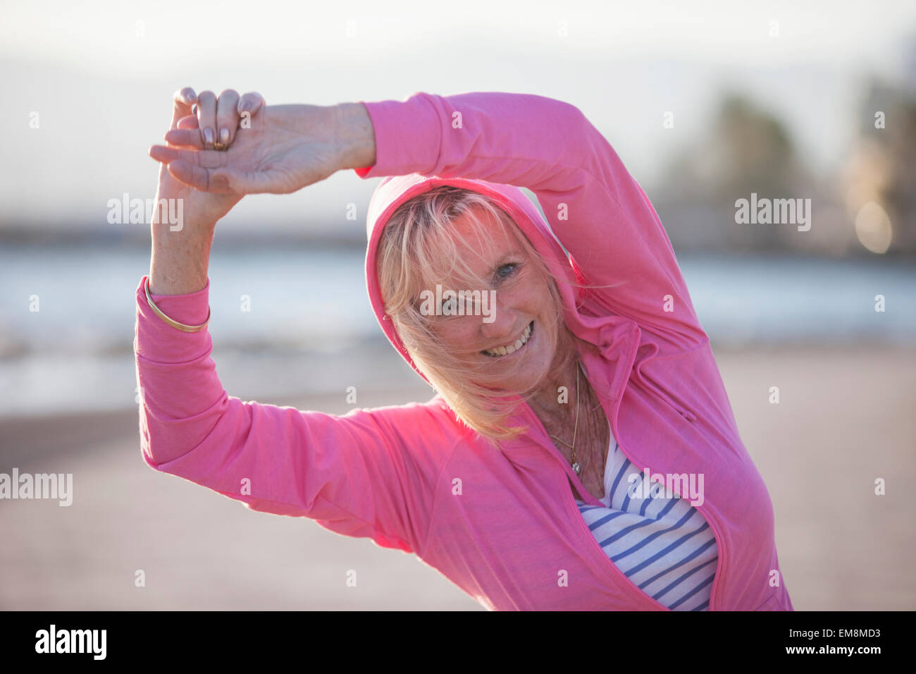 Woman stretching arms over head hi-res stock photography and images - Alamy