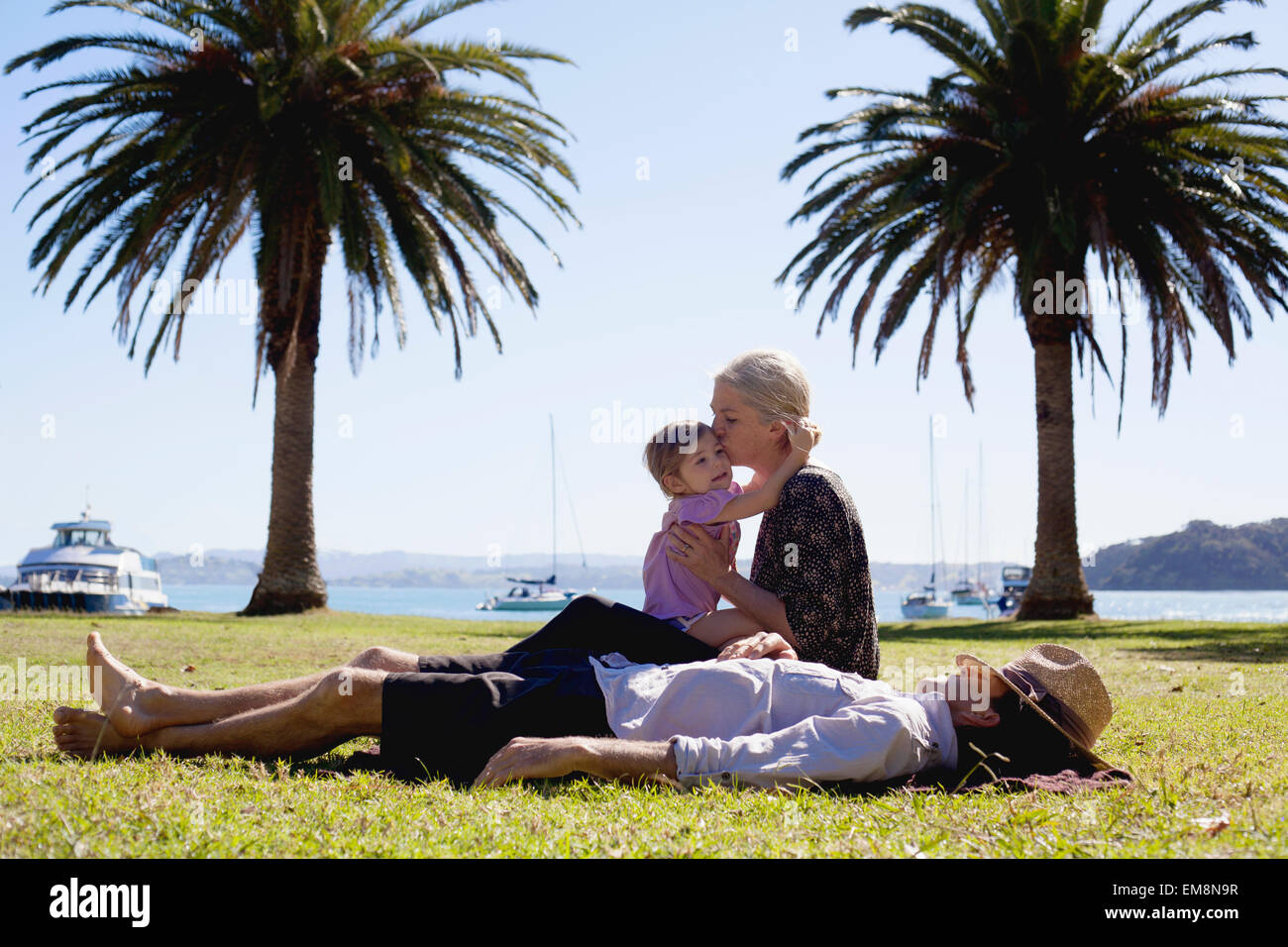 Mother and daughter hugging in coastal park, New Zealand Stock Photo