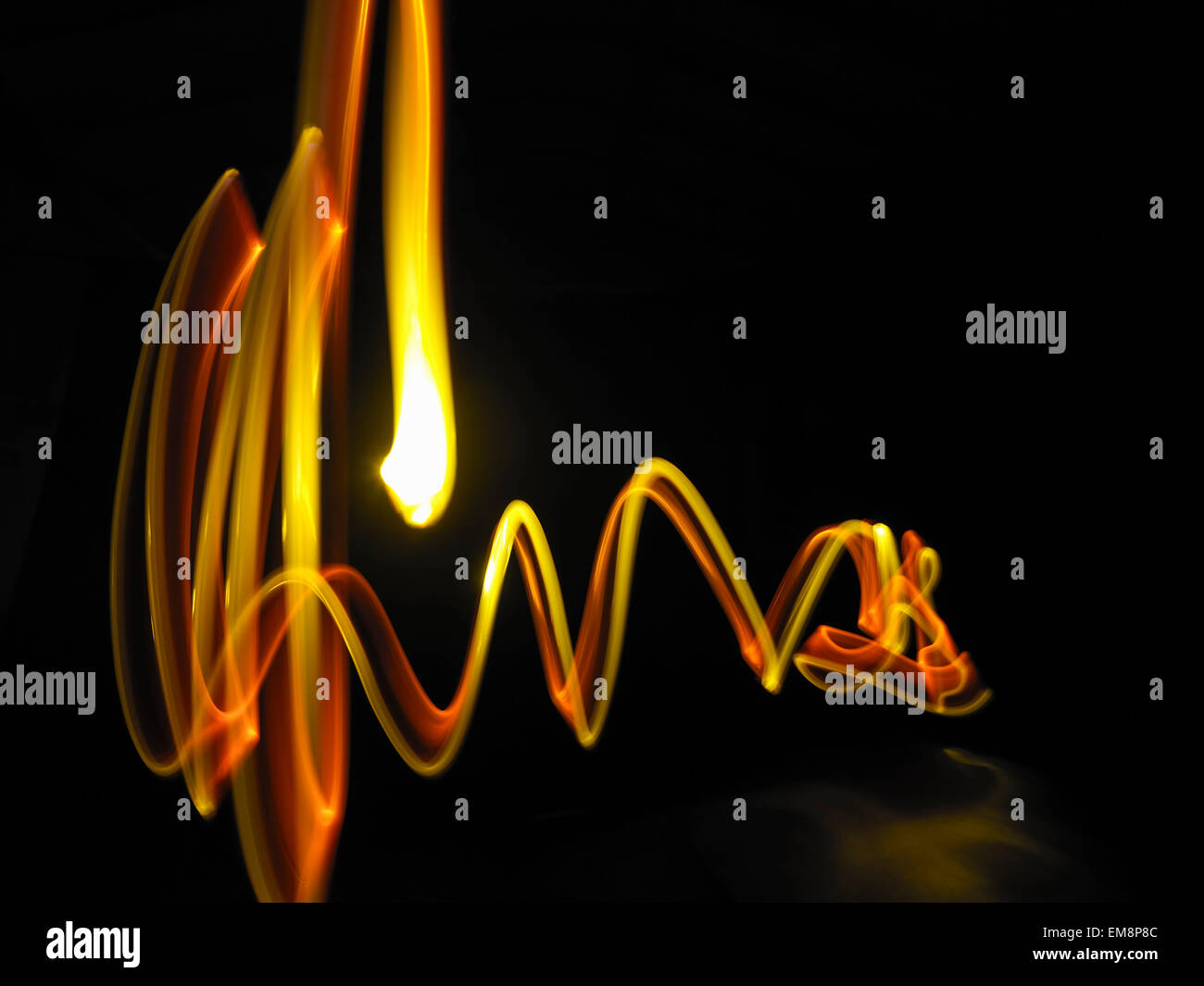 Abstract light trails made by molten metal against black background Stock Photo