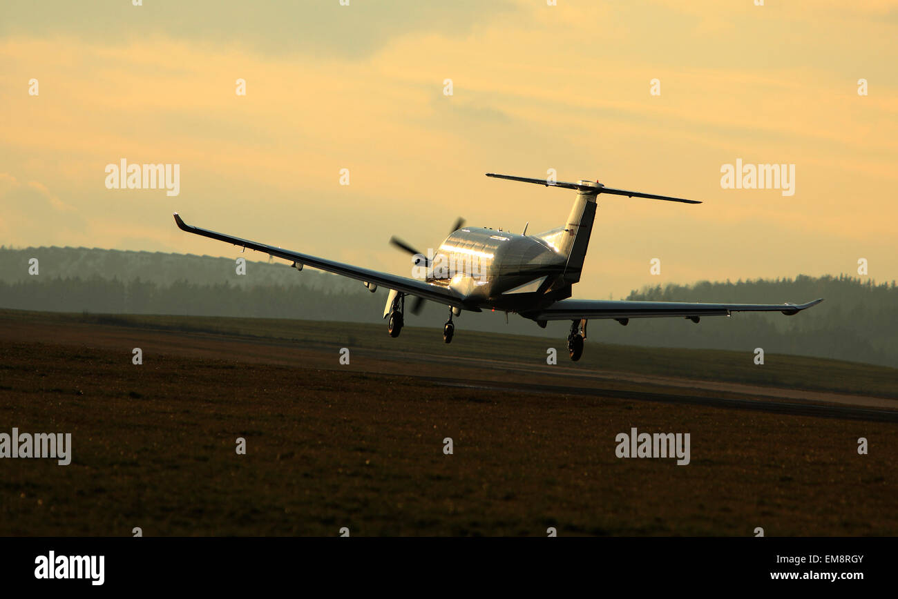 Single turboprop aircraft airplane taking off on airport. Stock Photo