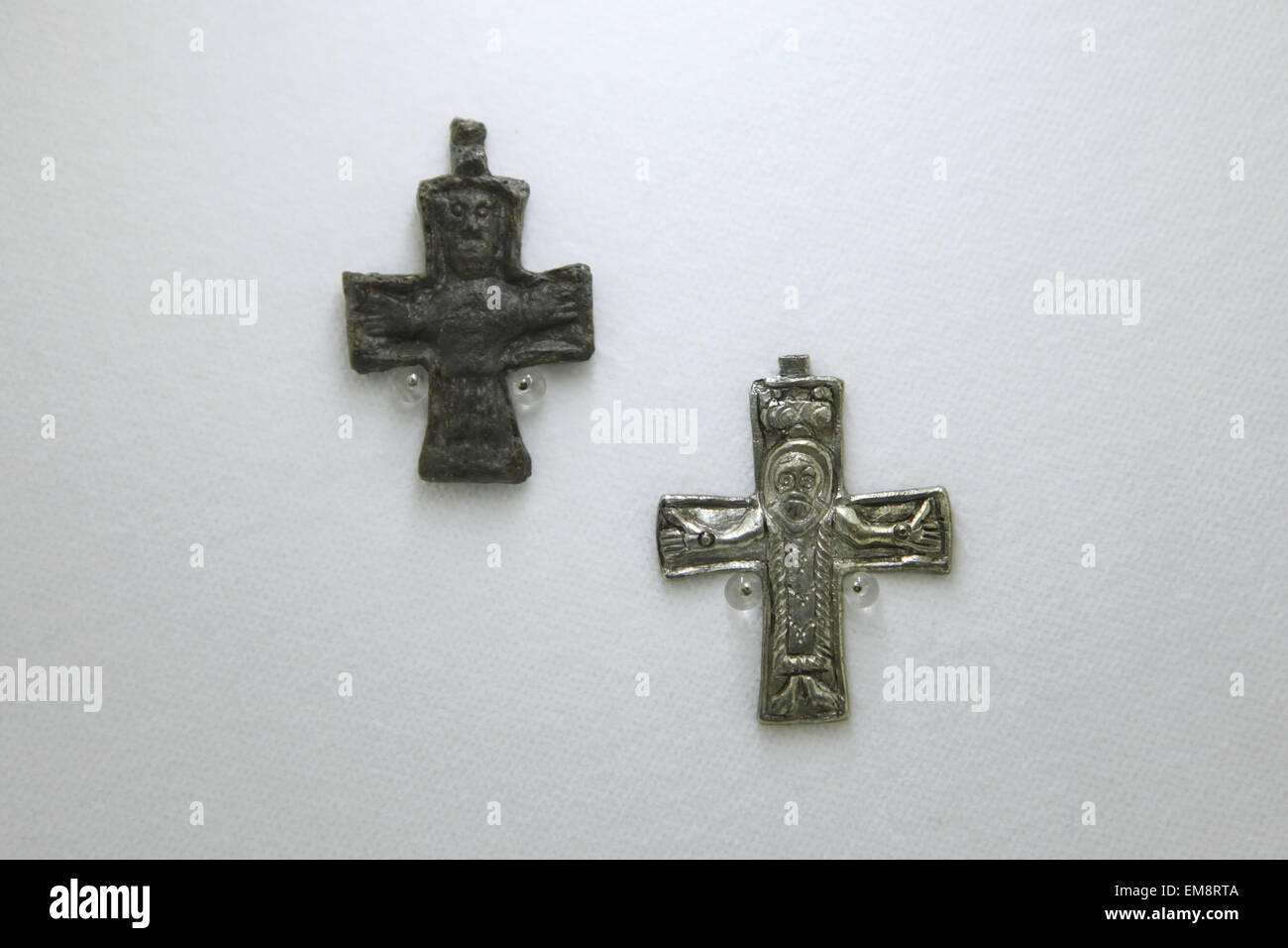 Great Moravian leaden and silver crosses with the image of the crucified Christ displayed at the exhibition 'Great Moravia and the Beginnings of Christianity' in Prague, Czech Republic. The crosses from the 9th century were discovered in Mikulcice, Czech Republic, the former capital city of the Great Moravian Empire. The exhibition presenting medieval treasures and original artefacts of the first Slavic state runs in Prague Castle till June 28, 2015. Stock Photo