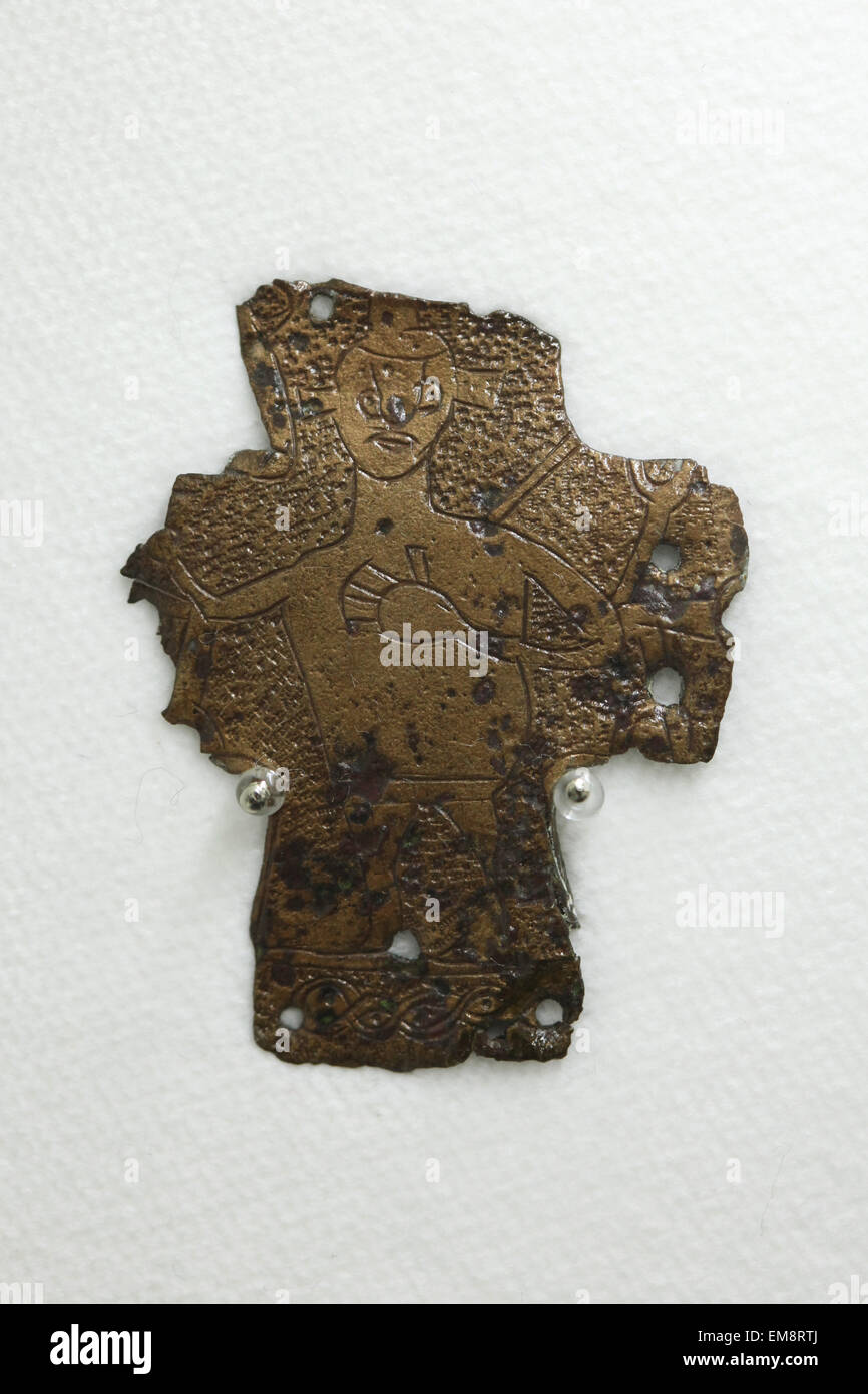 Great Moravian cooper cross decorated with an engraved figure displayed at the exhibition 'Great Moravia and the Beginnings of Christianity' in Prague, Czech Republic. The cross from the 9th century was discovered in Mikulcice, Czech Republic, the former capital city of the Great Moravian Empire. The exhibition presenting medieval treasures and original artefacts of the first Slavic state runs in Prague Castle till June 28, 2015. Stock Photo