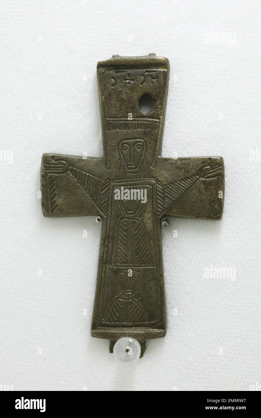Great Moravian bronze cross from Velka Maca decorated with engraved figures displayed at the exhibition 'Great Moravia and the Beginnings of Christianity' in Prague, Czech Republic. The Encolpion cross from the 10th century was discovered in the village of Velka Maca near Nitra, Slovakia. The cross used to be depicted on the 10 Slovak koruna coin. The exhibition presenting medieval treasures and original artefacts of the first Slavic state runs in Prague Castle till June 28, 2015. Stock Photo