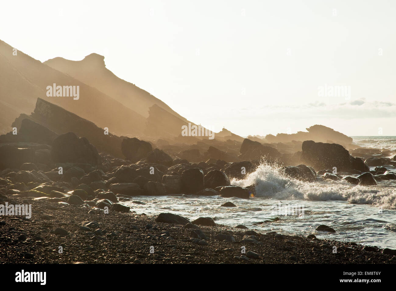 Silhouetted view of rocks on Millook Beach, Cornwall, UK Stock Photo ...