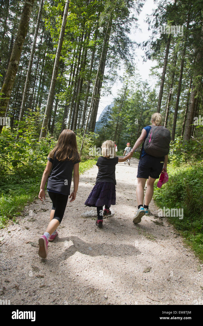 Rear view of mother and children hiking in forest, Berchtesgaden, Obersalzberg, Bavaria, Germany Stock Photo
