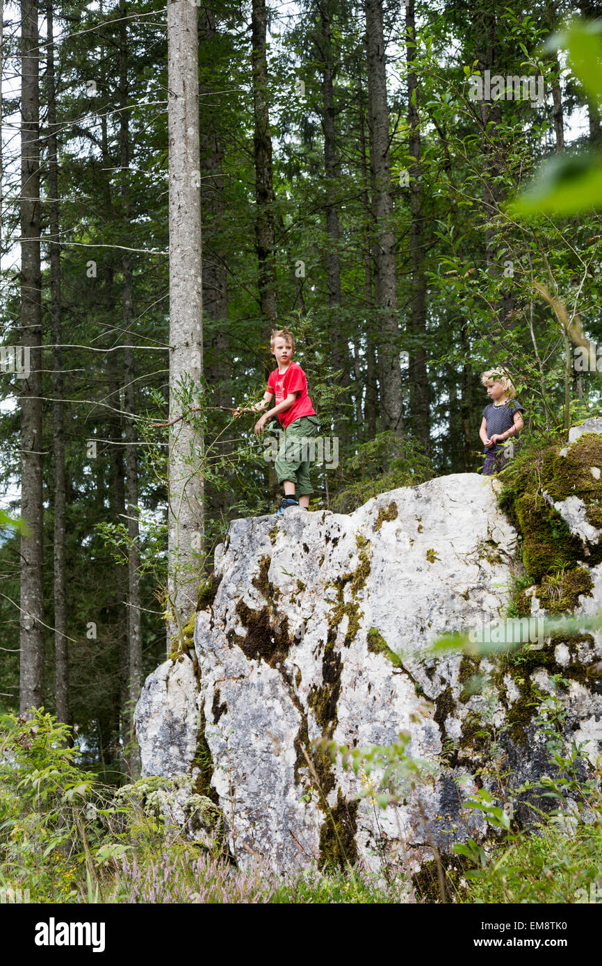 Brother and sister playing on rock formation in forest, Zauberwald, Bavaria, Germany Stock Photo