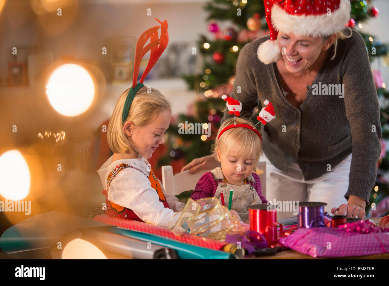 Mature woman wrapping christmas gift hi-res stock photography and ...