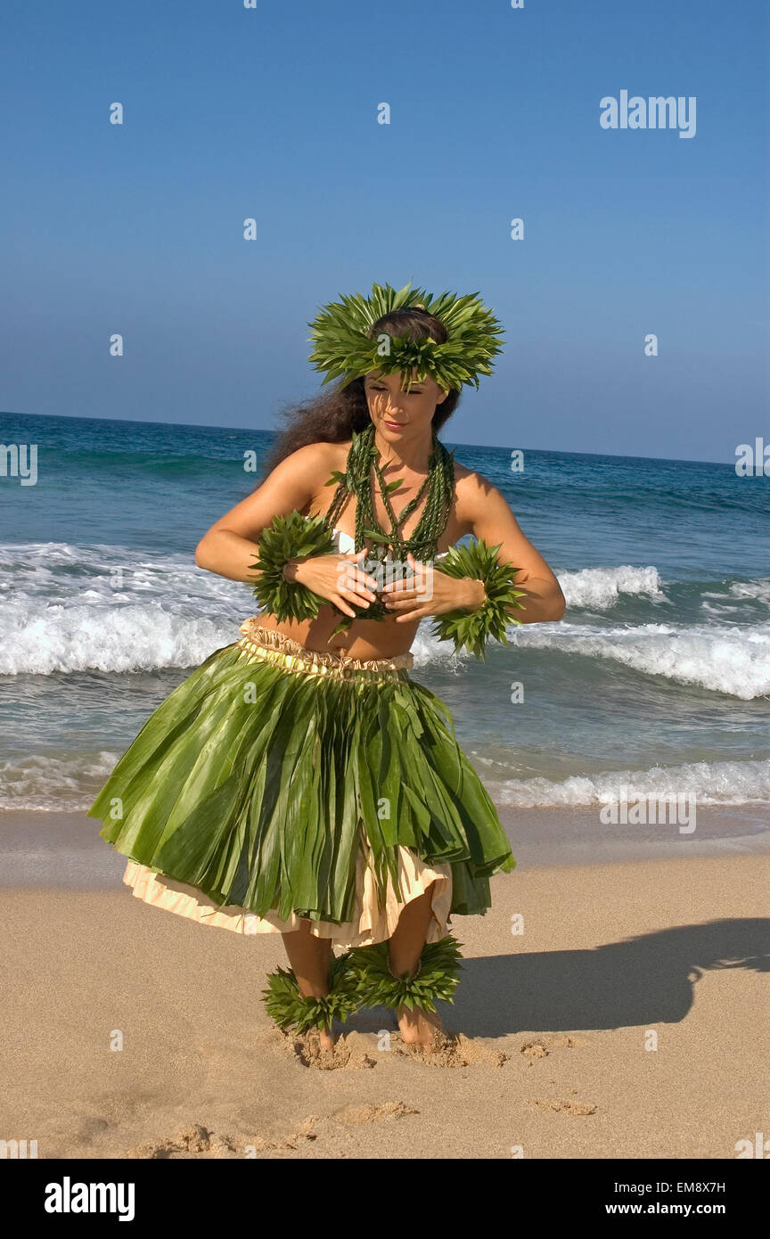 Hula Dancer In TiLeaf Skirt, Haku, Lei, In A Dancing Pose On The Beach